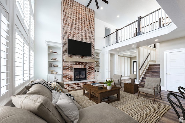 159 E 625 S, Mantua, UT 84324 - living room featuring a high ceiling, a brick fireplace, wood finished floors, a ceiling fan, and built in features