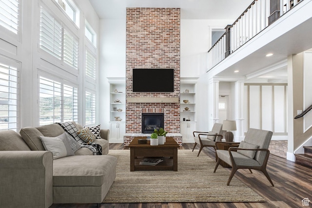159 E 625 S, Mantua, UT 84324 - living area featuring a towering ceiling, a brick fireplace, dark wood-style flooring, built in features, and baseboards