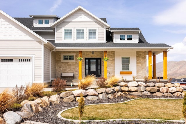 159 E 625 S, Mantua, UT 84324 - view of front of home featuring a porch, stone siding, a shingled roof, an attached garage, and a mountain view
