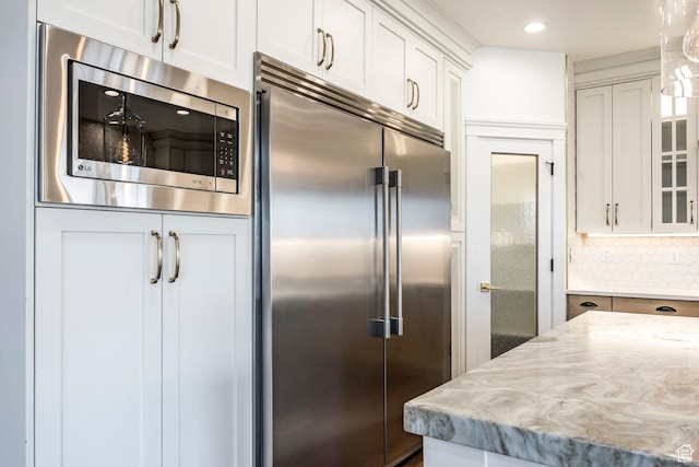 159 E 625 S, Mantua, UT 84324 - kitchen with built in appliances, glass insert cabinets, white cabinetry, light stone counters, and tasteful backsplash