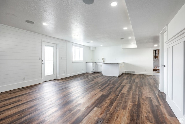 159 E 625 S, Mantua, UT 84324 - unfurnished living room with dark wood-type flooring, baseboards, a sink, recessed lighting, and a textured ceiling