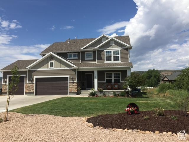 1962 Bluff Crest Rd Unit 4, Francis, UT 84036 - craftsman-style home featuring concrete driveway, board and batten siding, a front lawn, a garage, and covered porch