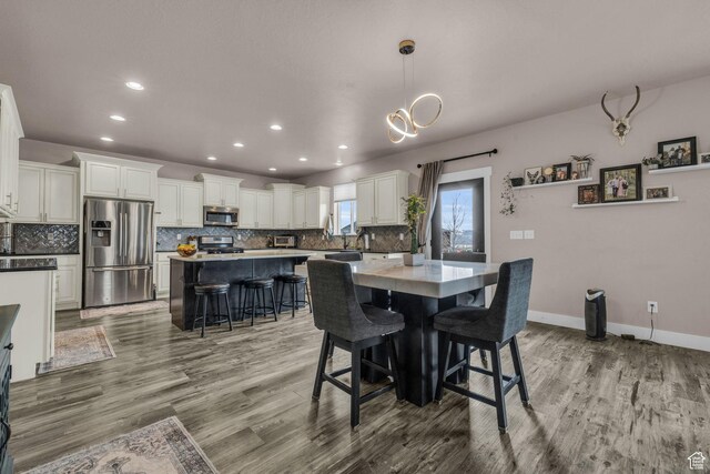 1962 Bluff Crest Rd Unit 4, Francis, UT 84036 - dining area featuring light wood-style flooring, recessed lighting, an inviting chandelier, and baseboards