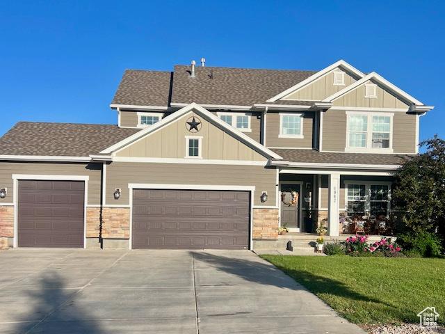 1962 Bluff Crest Rd Unit 4, Francis, UT 84036 - craftsman-style house featuring concrete driveway, covered porch, a front yard, an attached garage, and board and batten siding