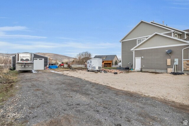 1962 Bluff Crest Rd Unit 4, Francis, UT 84036 - view of yard featuring a mountain view, an outbuilding, and dirt driveway