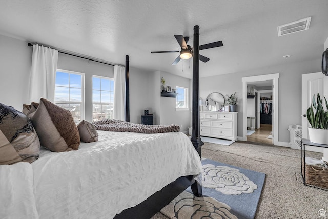 1962 Bluff Crest Rd Unit 4, Francis, UT 84036 - carpeted bedroom with a textured ceiling, a ceiling fan, visible vents, a walk in closet, and baseboards
