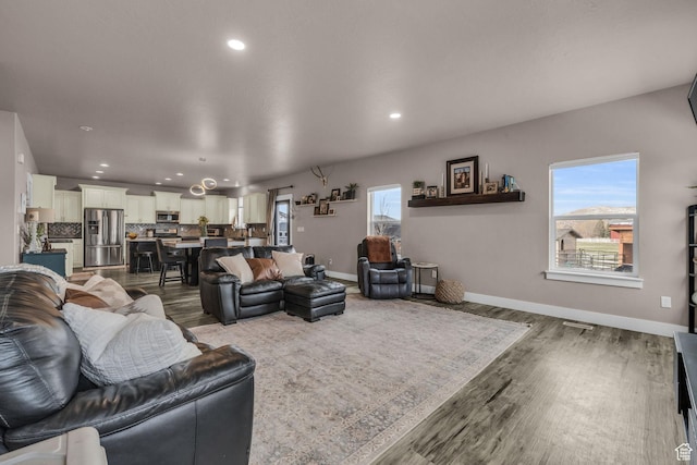 1962 Bluff Crest Rd Unit 4, Francis, UT 84036 - living area featuring a healthy amount of sunlight, wood finished floors, and recessed lighting