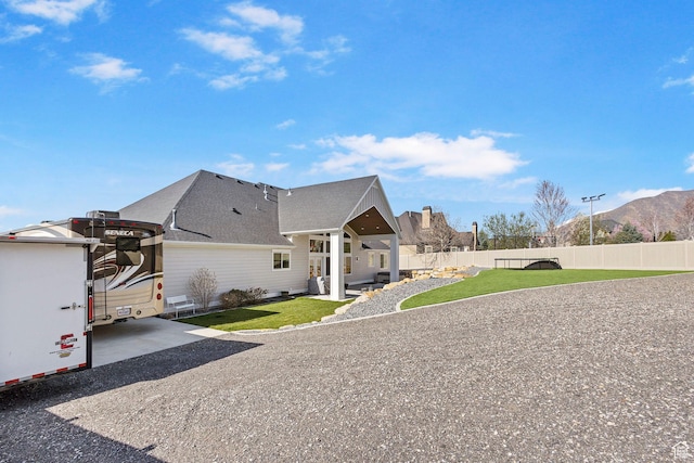 1125 S 400 E, Salem, UT 84653 - view of property exterior featuring a patio, roof with shingles, fence private yard, a mountain view, and a yard