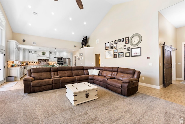 1125 S 400 E, Salem, UT 84653 - living room featuring baseboards, a ceiling fan, a barn door, visible vents, and high vaulted ceiling