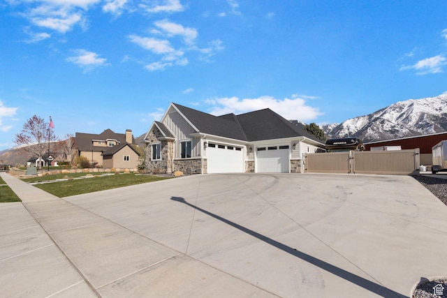 1125 S 400 E, Salem, UT 84653 - view of front of house featuring fence, stone siding, a gate, an attached garage, and driveway