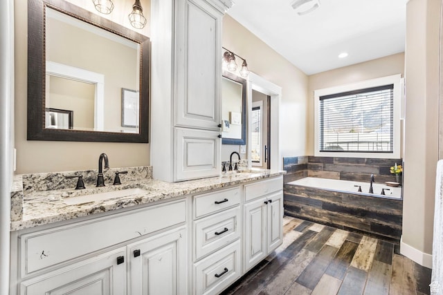 1125 S 400 E, Salem, UT 84653 - bathroom featuring double vanity, a bath, a sink, and wood finished floors