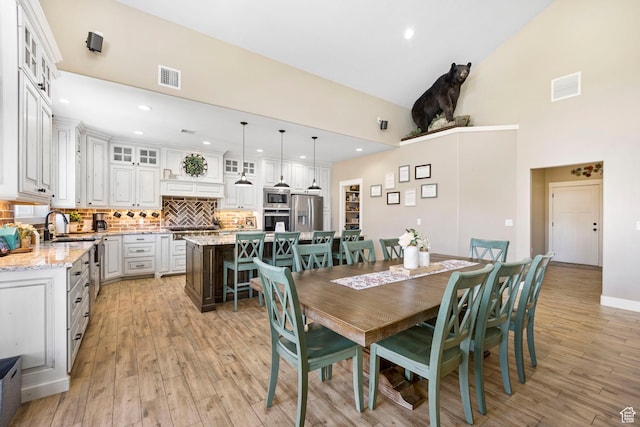 1125 S 400 E, Salem, UT 84653 - dining space with high vaulted ceiling, visible vents, and light wood-type flooring