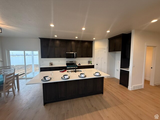 3758 W Alder Ct, Taylor, UT 84401 - kitchen featuring light countertops, light wood finished floors, appliances with stainless steel finishes, and a sink
