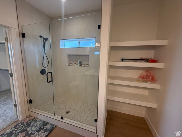 3758 W Alder Ct, Taylor, UT 84401 - bathroom featuring baseboards, a stall shower, and wood finished floors