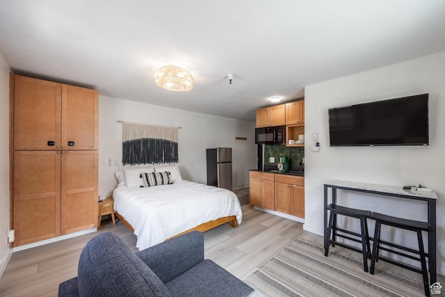 1940 Prospector Ave Unit 101, Park City, UT 84060 - bedroom with light wood-type flooring and freestanding refrigerator