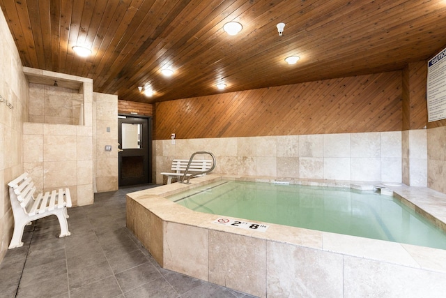 1940 Prospector Ave Unit 101, Park City, UT 84060 - bathroom featuring a bath, tile patterned floors, wooden ceiling, and tile walls