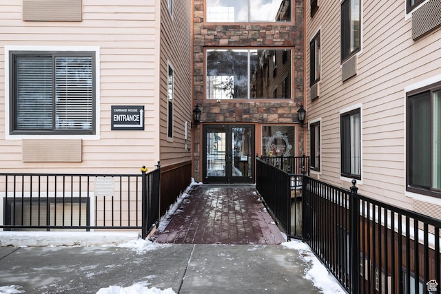 1940 Prospector Ave Unit 101, Park City, UT 84060 - snow covered property entrance featuring french doors, stone siding, and fence