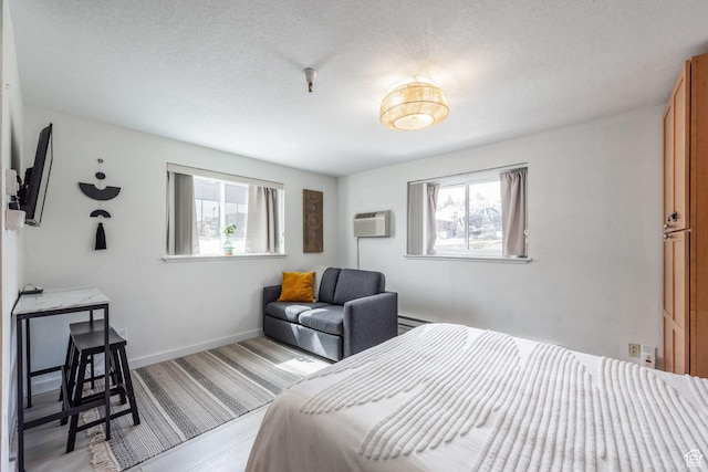 1940 Prospector Ave Unit 101, Park City, UT 84060 - bedroom featuring baseboards, a wall unit AC, and a textured ceiling