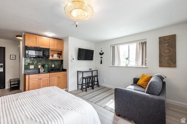 1940 Prospector Ave Unit 101, Park City, UT 84060 - bedroom with a sink, light wood finished floors, and baseboards