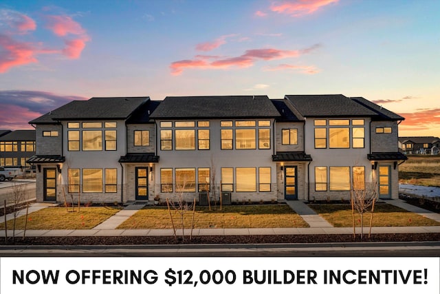 4342 W 5430 S Unit A, Hooper, UT 84315 - view of front of house featuring a standing seam roof, stucco siding, a metal roof, and stone siding