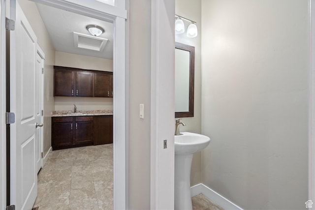 bathroom featuring a sink and baseboards