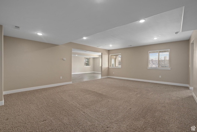 unfurnished room featuring recessed lighting, baseboards, visible vents, and carpet floors