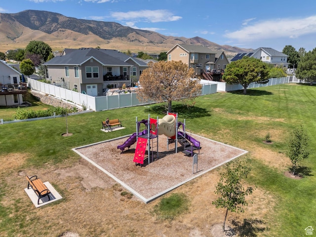 4071 S Sandpiper Ln, Saratoga Springs, UT 84045 - view of playground featuring fence, a residential view, a mountain view, and a lawn