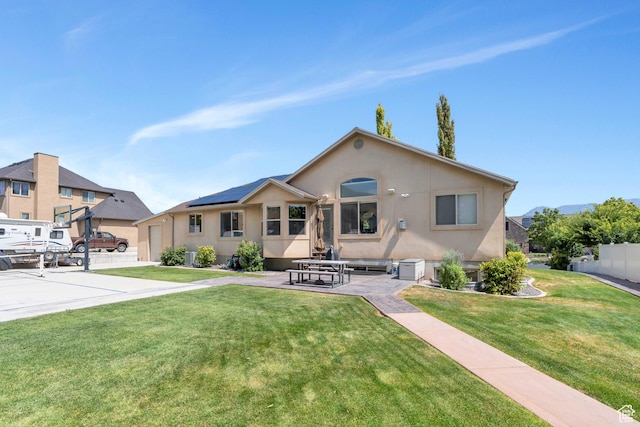4071 S Sandpiper Ln, Saratoga Springs, UT 84045 - rear view of property with fence, a patio, a lawn, and stucco siding