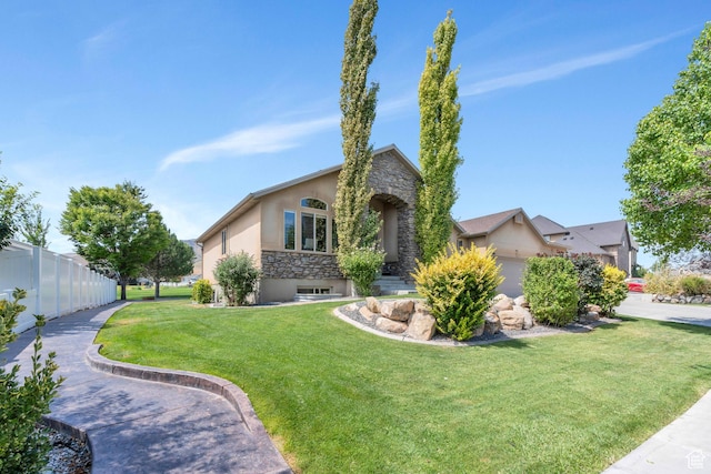 4071 S Sandpiper Ln, Saratoga Springs, UT 84045 - view of front of home with a front yard, fence, stone siding, and stucco siding
