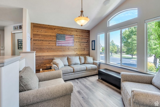 4071 S Sandpiper Ln, Saratoga Springs, UT 84045 - living area with a wealth of natural light, wooden walls, an accent wall, and light wood-type flooring