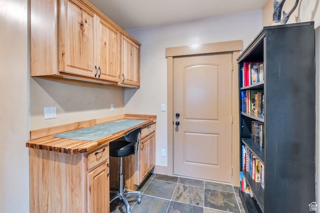 4071 S Sandpiper Ln, Saratoga Springs, UT 84045 - kitchen featuring wooden counters, light brown cabinetry, built in study area, and stone finish flooring