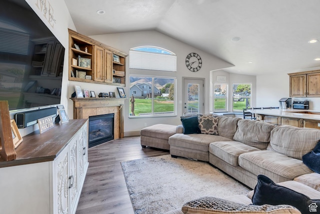 4071 S Sandpiper Ln, Saratoga Springs, UT 84045 - living room with a tiled fireplace, recessed lighting, light wood finished floors, vaulted ceiling, and a toaster