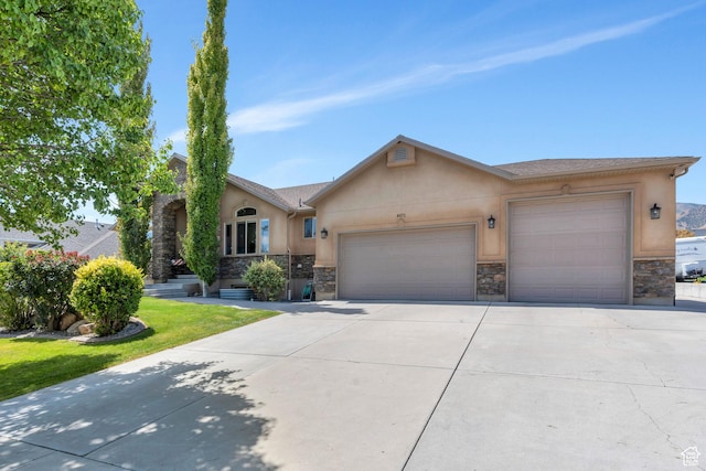 4071 S Sandpiper Ln, Saratoga Springs, UT 84045 - view of front of house with a front yard, an attached garage, stone siding, concrete driveway, and stucco siding