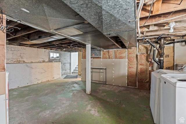 basement with washing machine and dryer and stairway