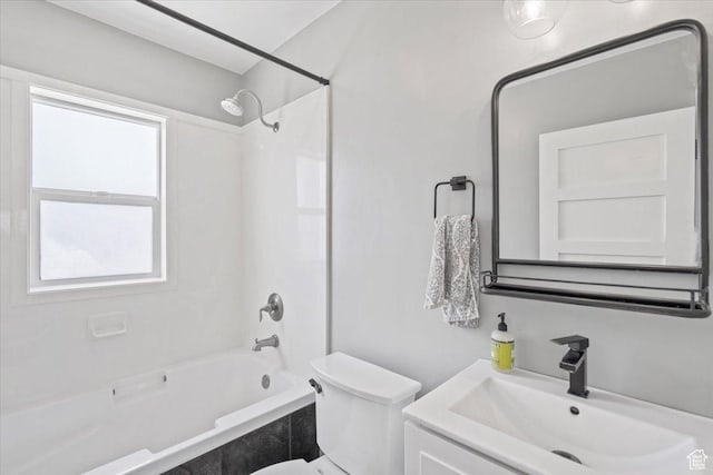 bathroom with bathing tub / shower combination, vanity, and toilet