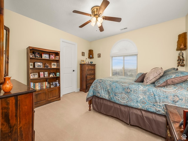 bedroom with carpet, visible vents, and ceiling fan