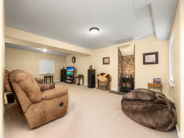 living area featuring baseboards, visible vents, and carpet floors