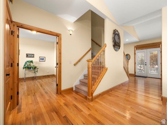 stairs featuring hardwood / wood-style floors, french doors, baseboards, and recessed lighting