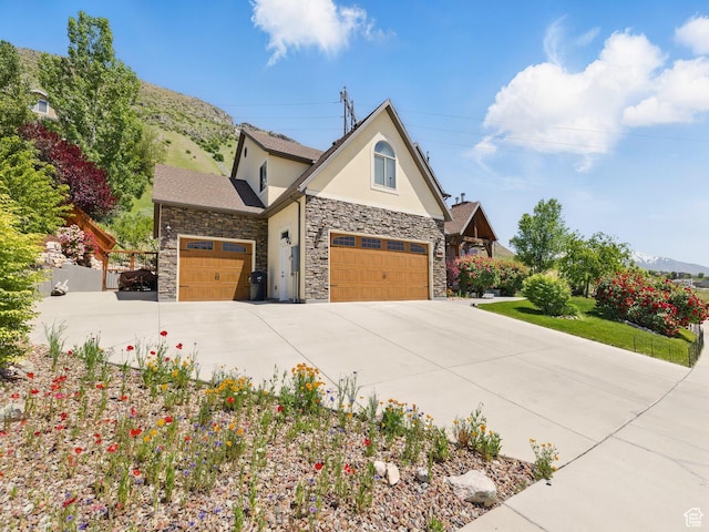 1411 S Slate Canyon Dr, Provo, UT 84606 - view of front of home with stucco siding, stone siding, concrete driveway, and an attached garage