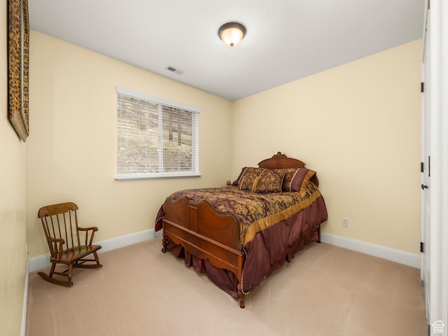 carpeted bedroom featuring visible vents and baseboards