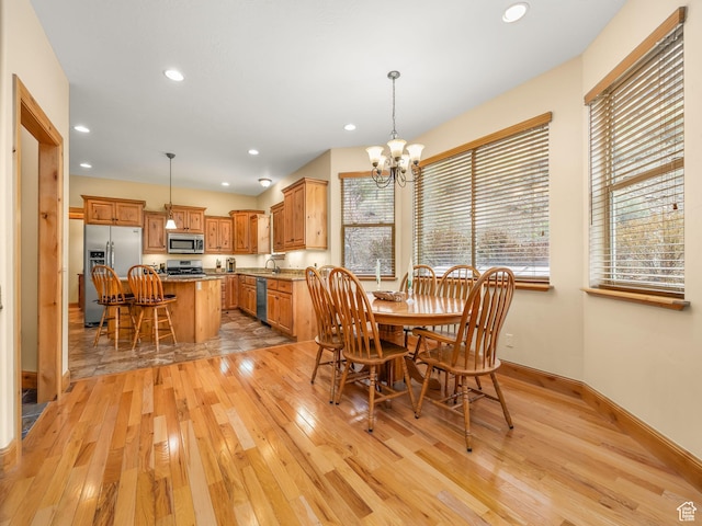 dining area with a chandelier, light wood-style floors, baseboards, and recessed lighting