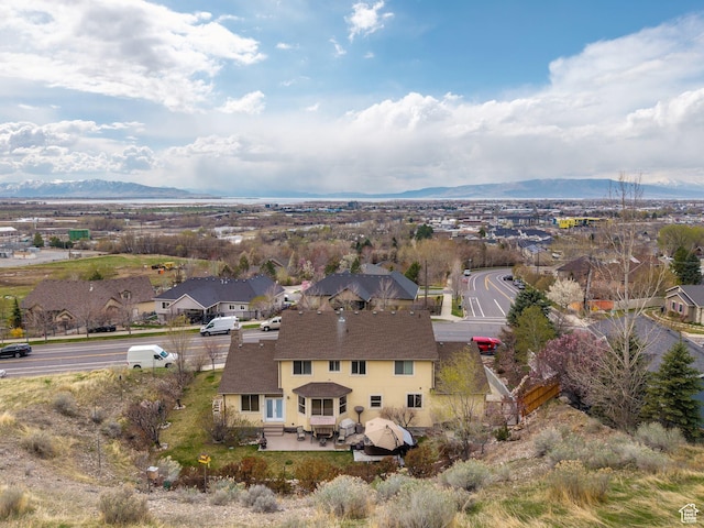birds eye view of property with a mountain view and a residential view