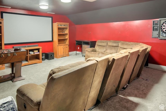 carpeted cinema with baseboards and vaulted ceiling