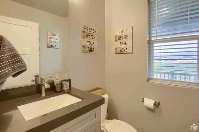 half bathroom featuring toilet and vanity