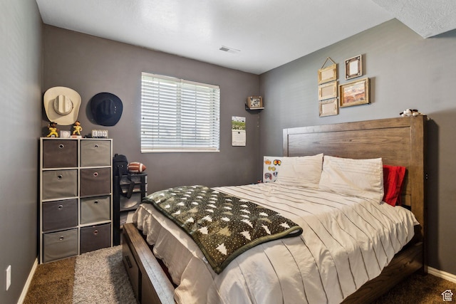 carpeted bedroom with visible vents and baseboards
