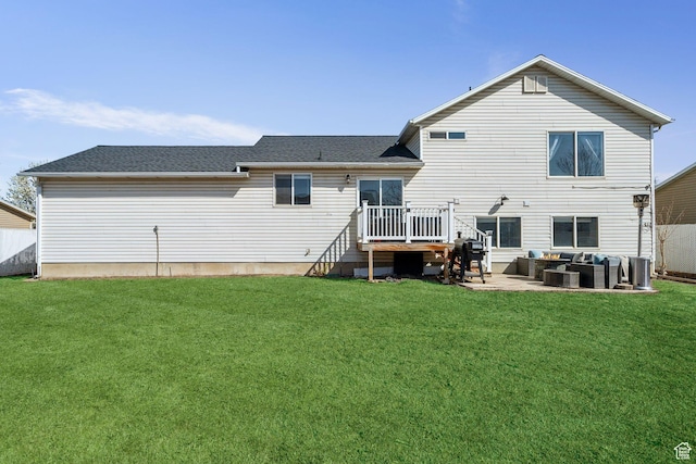 rear view of property featuring an outdoor hangout area, a lawn, roof with shingles, a patio area, and a deck