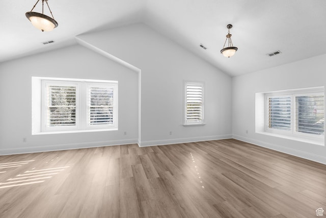 interior space with visible vents, light wood-type flooring, and lofted ceiling
