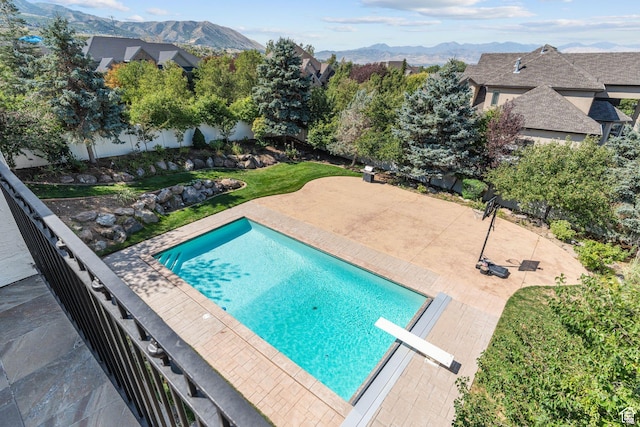 view of swimming pool featuring a patio area and a mountain view