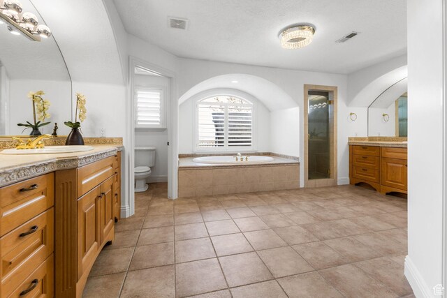 full bath with a garden tub, a shower stall, visible vents, toilet, and a sink