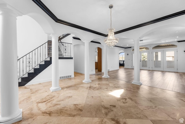 unfurnished dining area featuring baseboards, ornamental molding, visible vents, and stairs